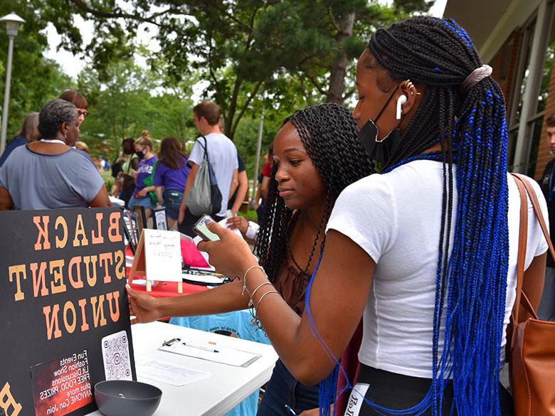 Students visiting the Black Student Union booth at the involvement fair